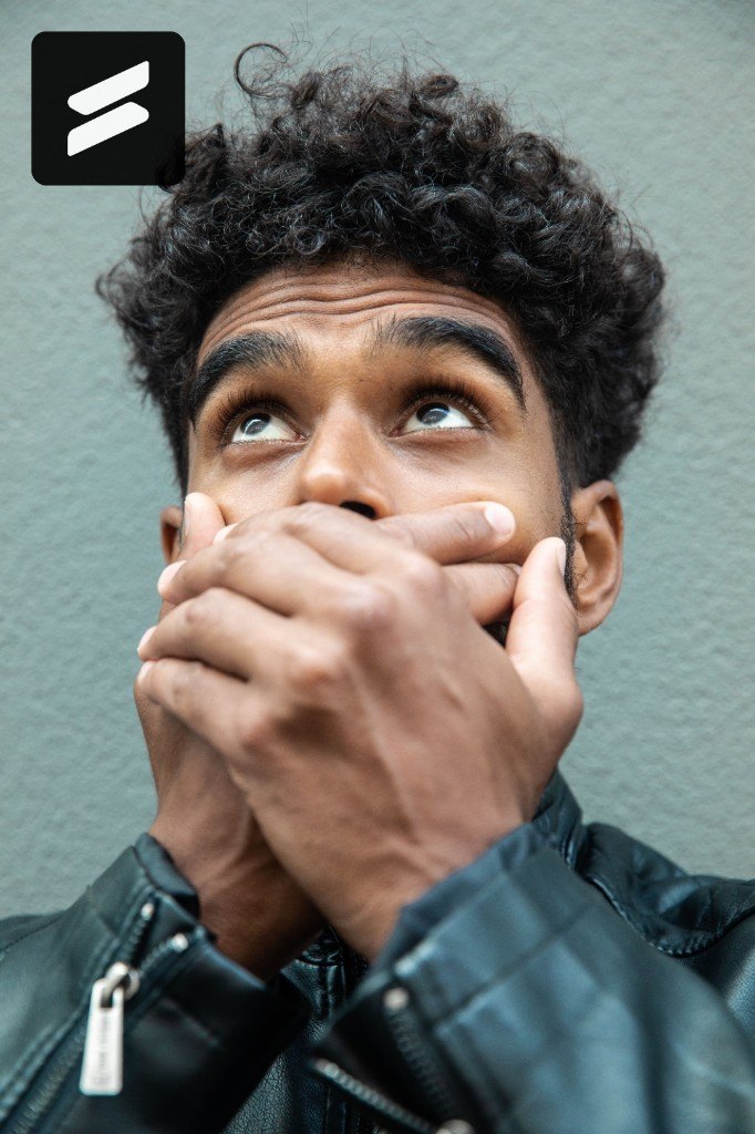 Person covering their mouth with both hands