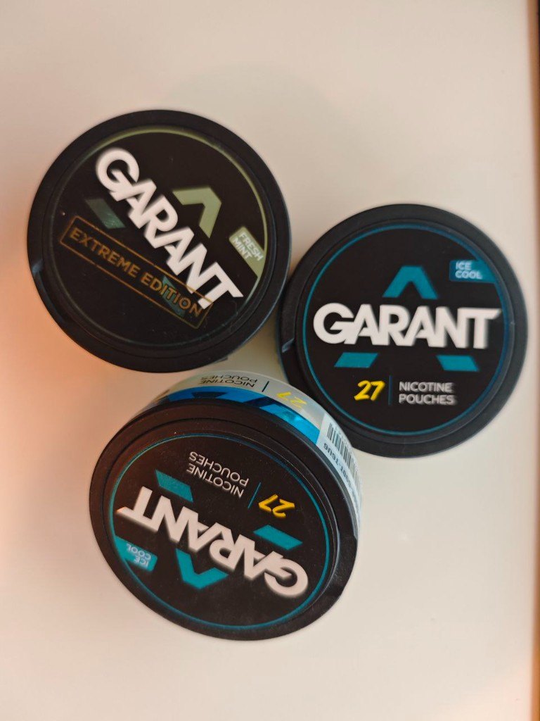 Three cans of Garant nicotine pouches