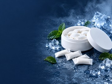Open white can of nicotine pouches with mint and ice